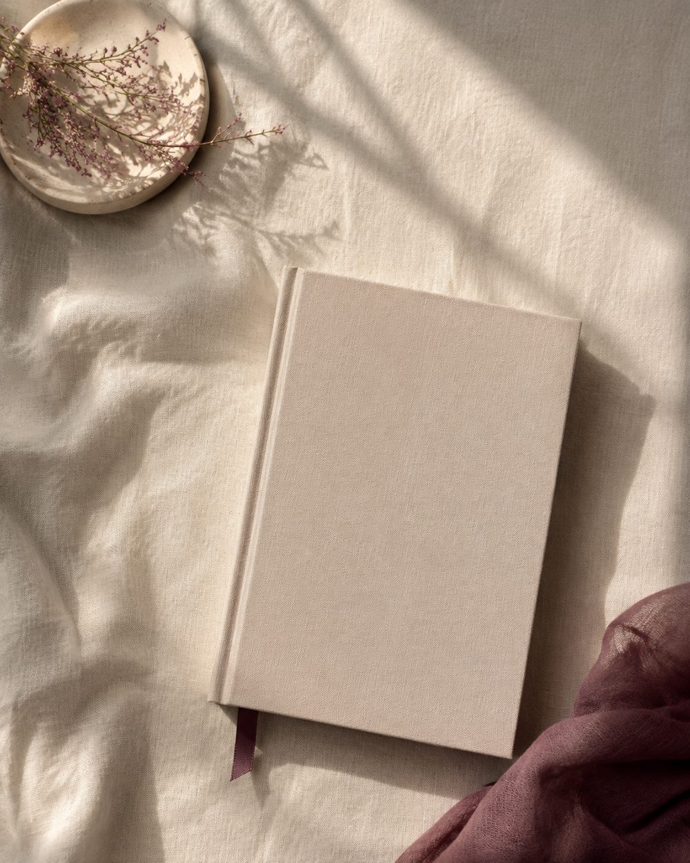 A closed devotional book resting on linen, seen from above